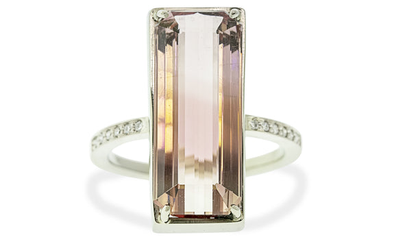 10 carat emerald cut pink tourmaline ring set in 14 karat white gold with six white pavé diamonds on each shoulder front view on white background