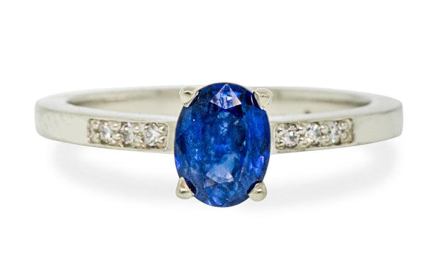 .88 carat blue sapphire with three white pave diamonds on each side front view on white background