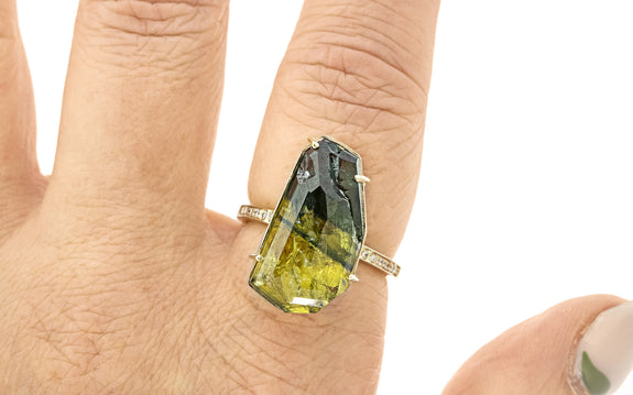 19.32 carat double cut green and yellow sapphire ring in 14 karat yellow gold with six white pavé on each shoulder top view on finger