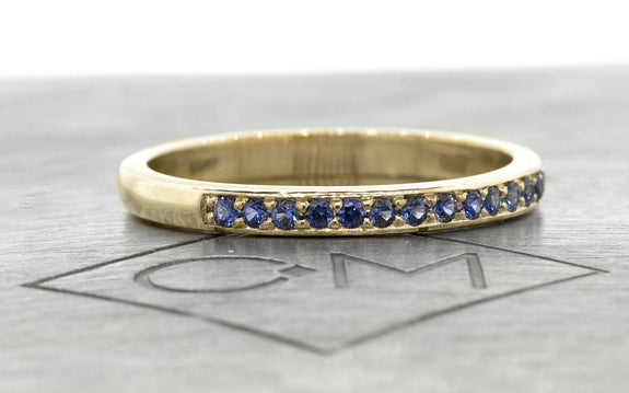 Wedding Band with 16 Blue Sapphires side view on logo