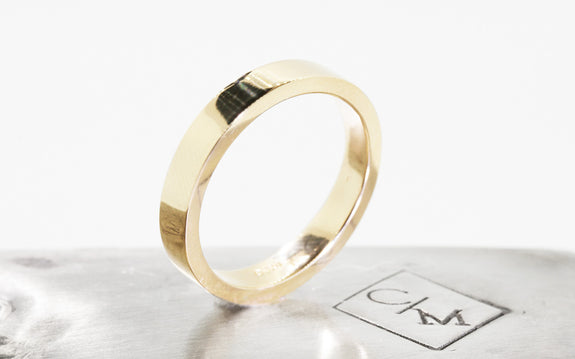 Men's Flat Gold Wedding Band up on its side